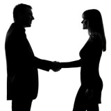 silhouette image of a man and woman shaking hands
