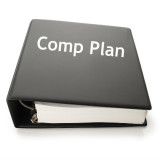 thick black binder with words "Comp Plan" on cover