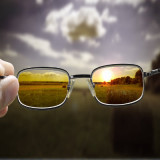 photo of countryside seen through pair of sun glasses