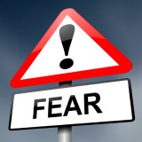 road sign with the word "Fear" on it.