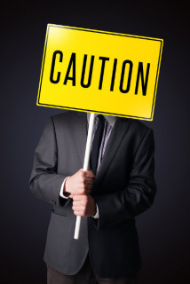 man holding a Caution sign