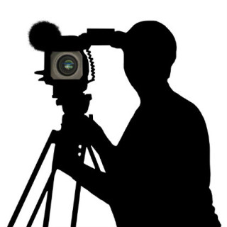person using a video camera in silhouette