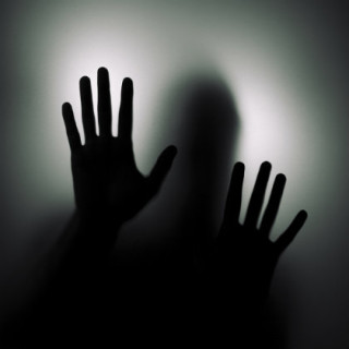 blurred mysterious image of map groping with two hands in the dark.