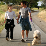 photo of a young couple walking their dog