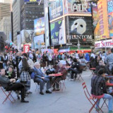 People enjoying new seating opportunities on Broadway in heart of Manhattan
