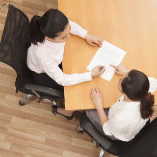 photo of two individuals sitting across from each other at a table