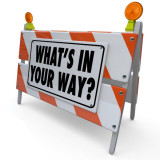 image of road barrier that says "What's In Your Way?"