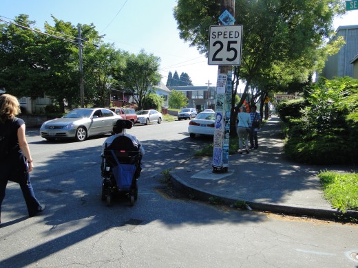 Motorized wheelchair user trying to cross street.