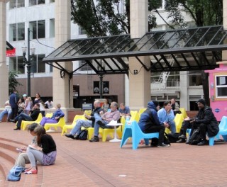 People sitting and talking in Pioneer Courthouse Square.